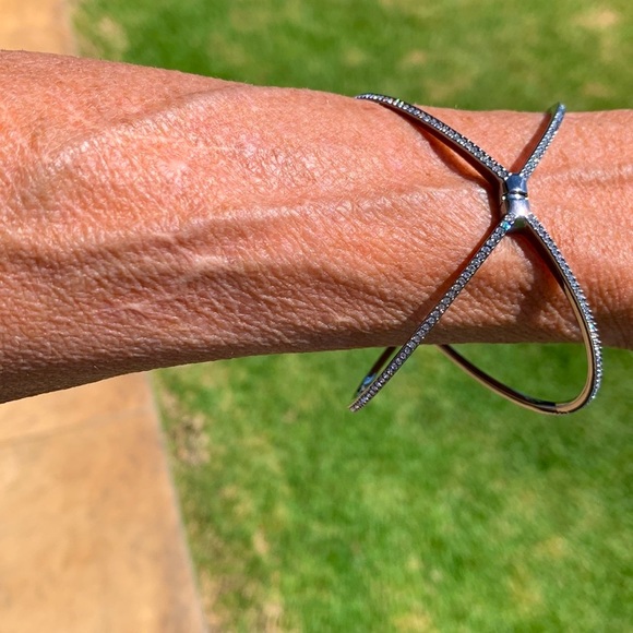 A beautiful silver bracelet with crystals on the outside of the bracelet. - Picture 8 of 8